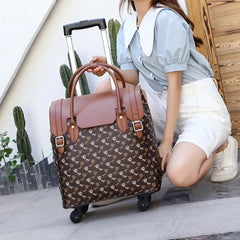 View of a crouching model holding the trolley bag using the hand-carry straps