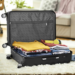 Interior details of the black-colored 20-inch rolling case show packed clothes, a zipper partitioner with a built-in zipper pocket to stash small items